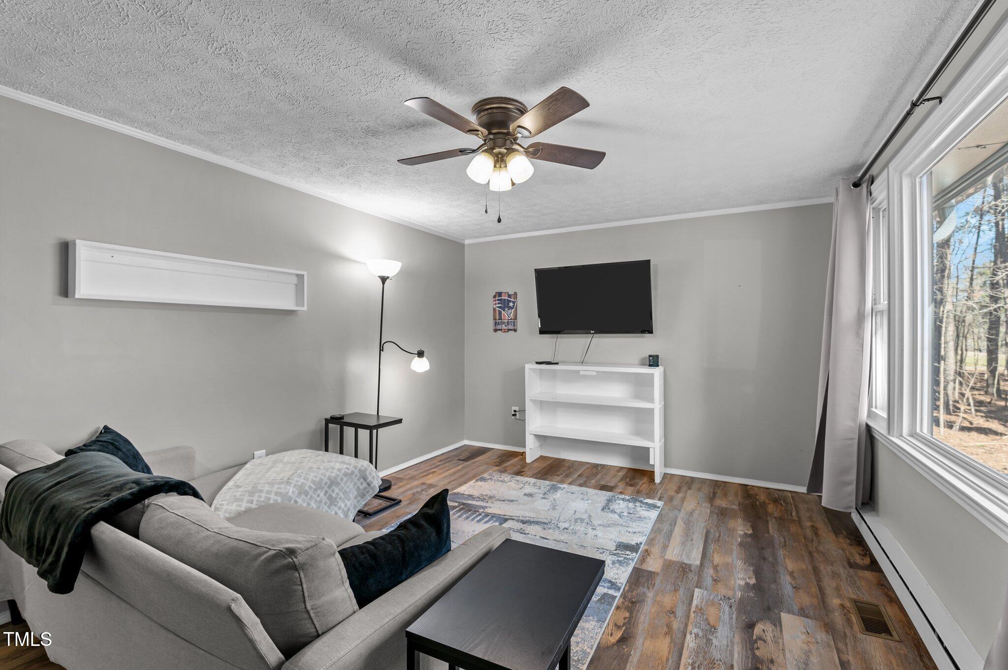 749 Fred Royster Road Henderson, NC 27537 - Photo 4 of 31 a living room with furniture and a flat screen tv
