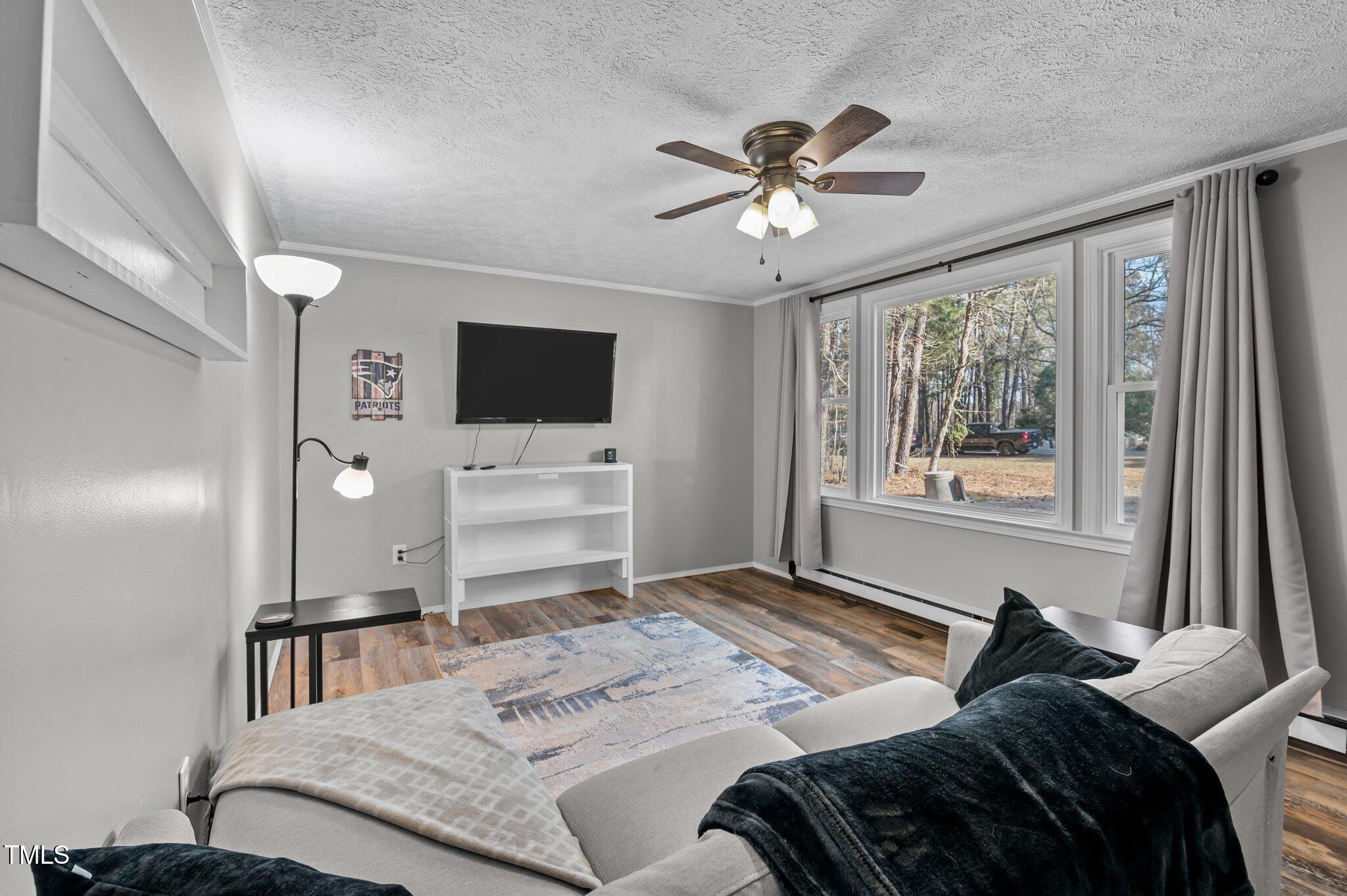 749 Fred Royster Road Henderson, NC 27537 - Photo 5 of 31 a bedroom with a bed and a flat screen tv