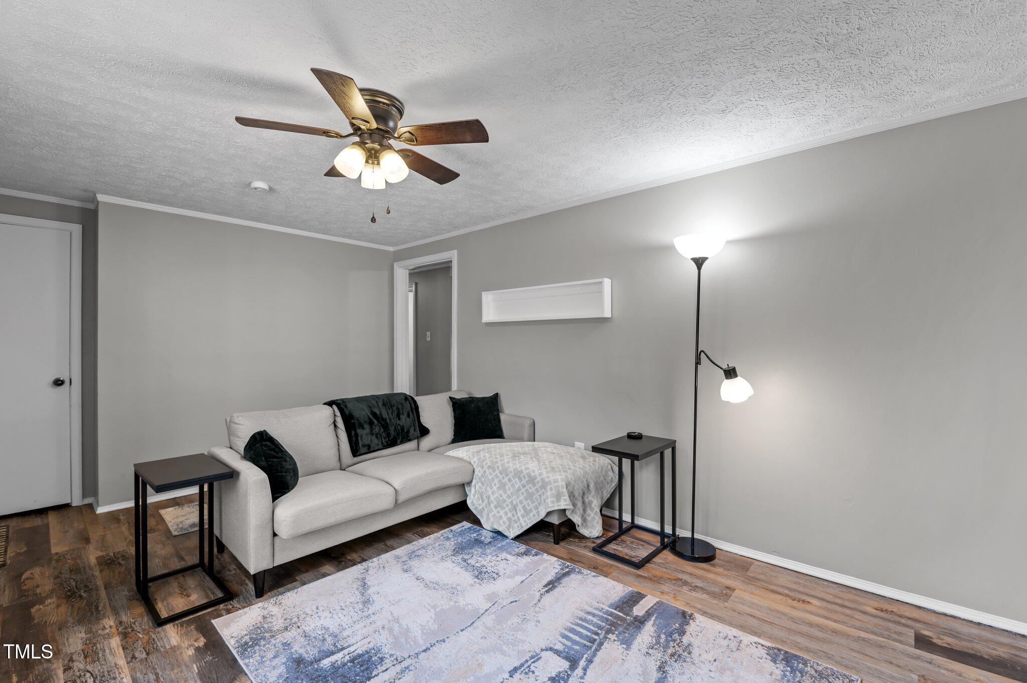 749 Fred Royster Road Henderson, NC 27537 - Photo 6 of 31 a living room with couch and a ceiling fan