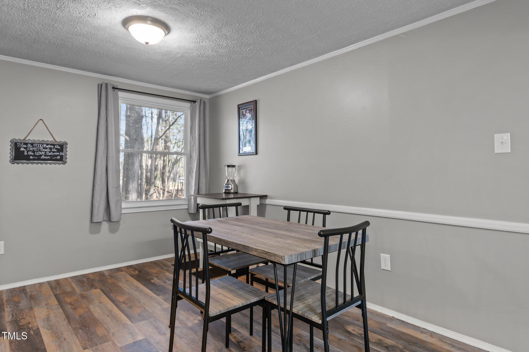 749 Fred Royster Road Henderson, NC 27537 - Photo 8 of 31 a view of a dining room with furniture and windows