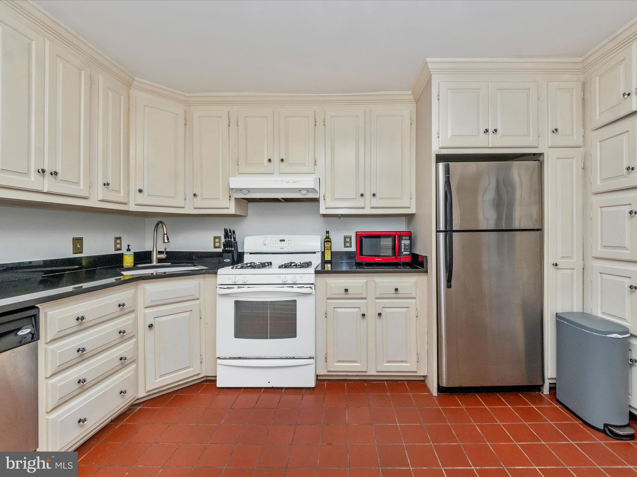 23 East Wheeling Street Baltimore, MD 21230 - Photo 13 of 51 a kitchen with stainless steel appliances granite countertop a refrigerator sink and white cabinets