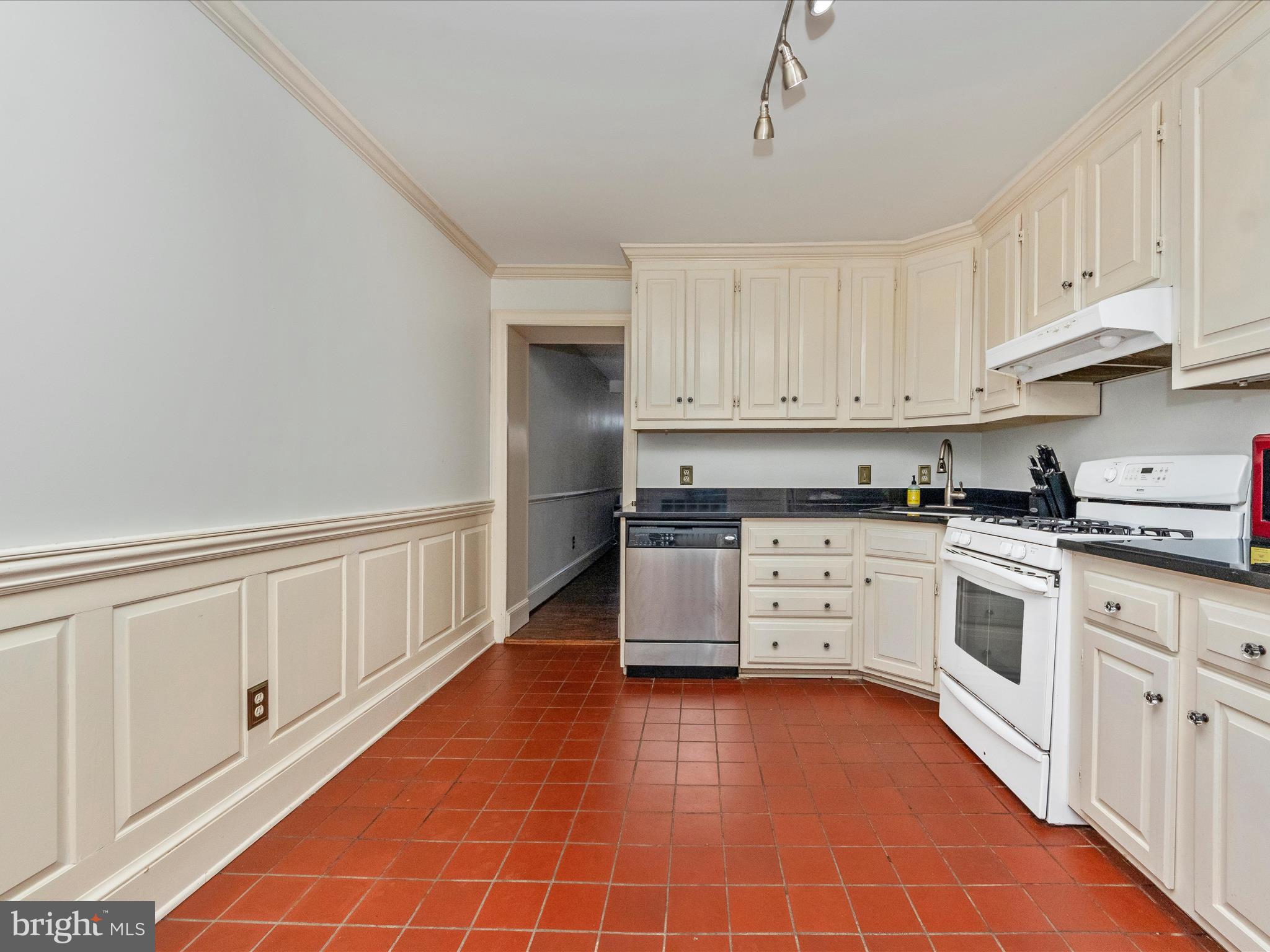 23 East Wheeling Street Baltimore, MD 21230 - Photo 15 of 51 a kitchen with stainless steel appliances a white stove top oven and white cabinets