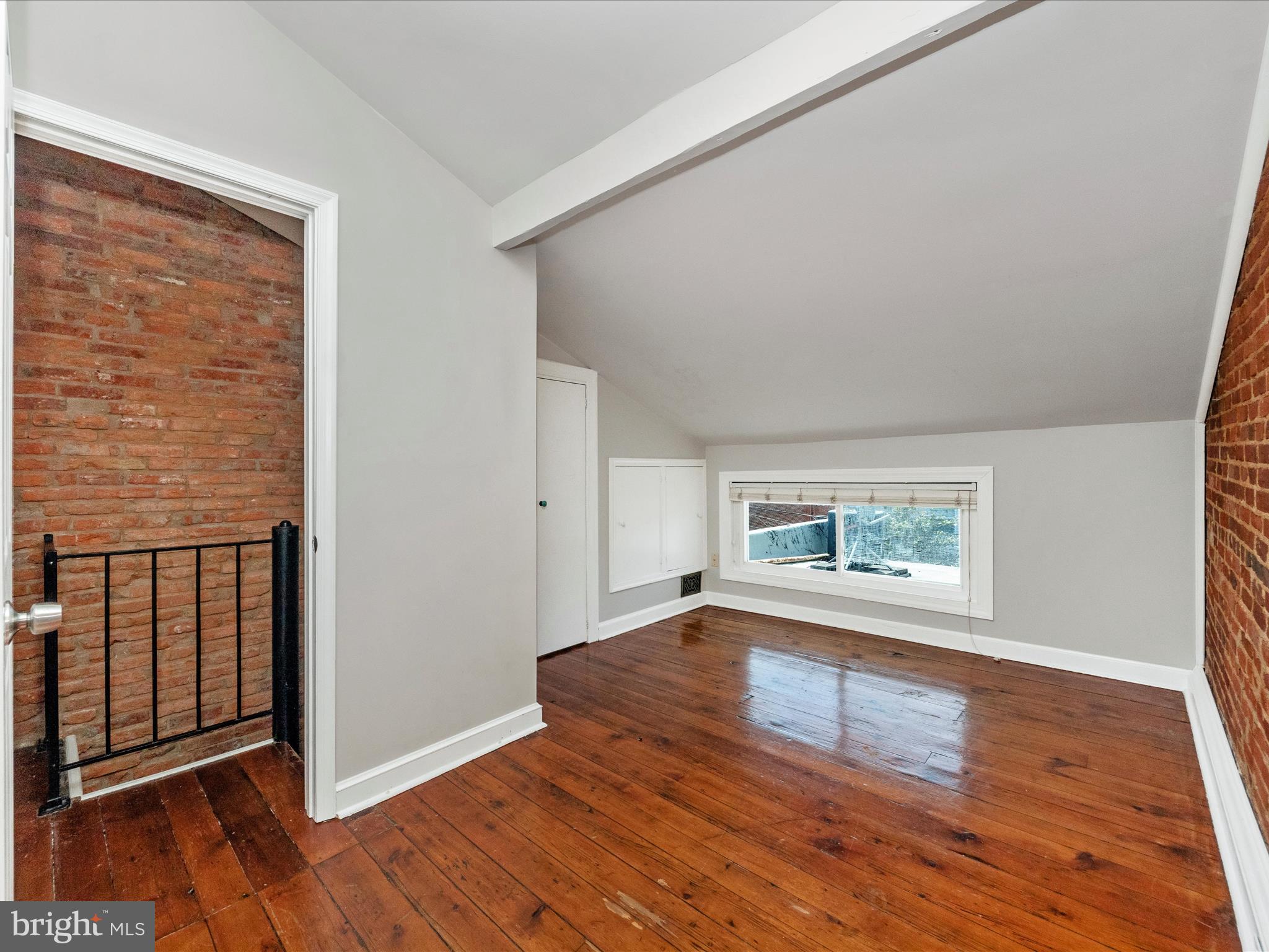 23 East Wheeling Street Baltimore, MD 21230 - Photo 18 of 51 an empty room with wooden floor and windows