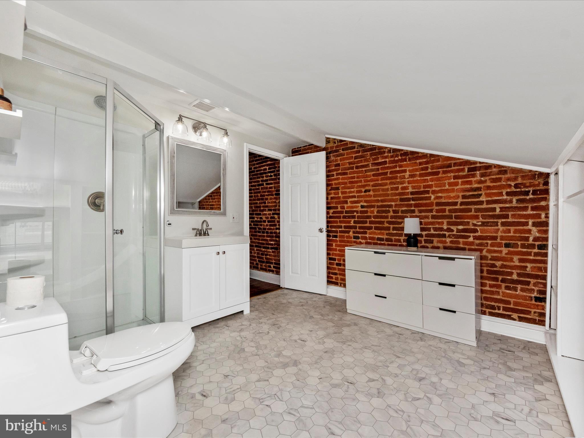 23 East Wheeling Street Baltimore, MD 21230 - Photo 25 of 51 a bathroom with a toilet sink and shower