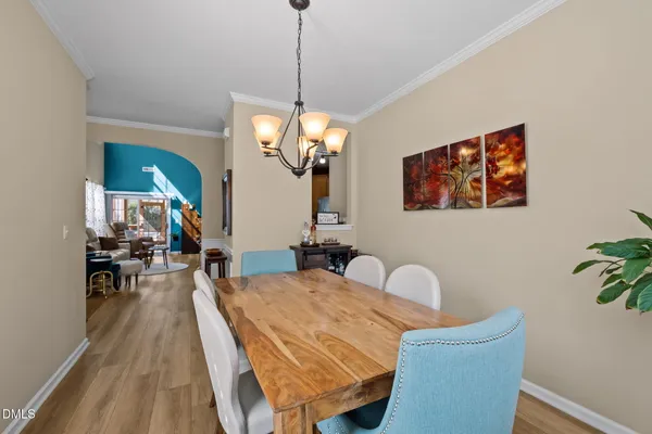a dining room with furniture and wooden floor