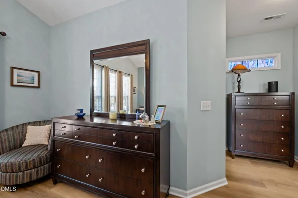 a living room with a couch and a dresser