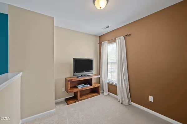 a view of a livingroom with entryway and a window
