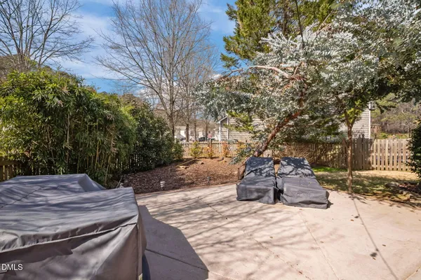 a wooden bench sitting in middle of a yard