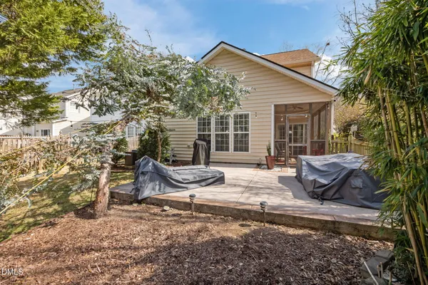 a view of a house with backyard and sitting area