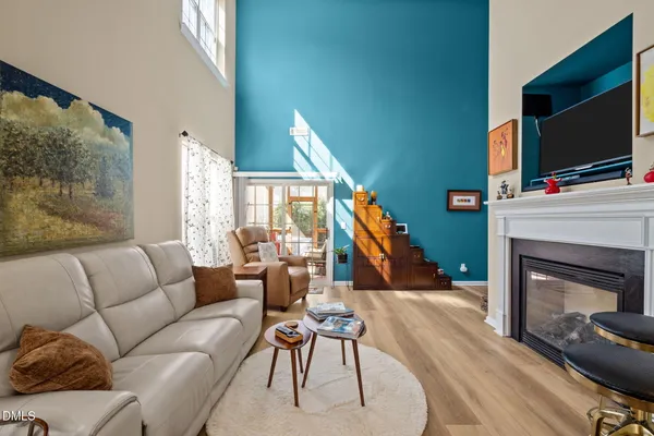 a living room with furniture a flat screen tv and a fireplace