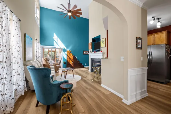 a dining room with furniture a chandelier and wooden floor