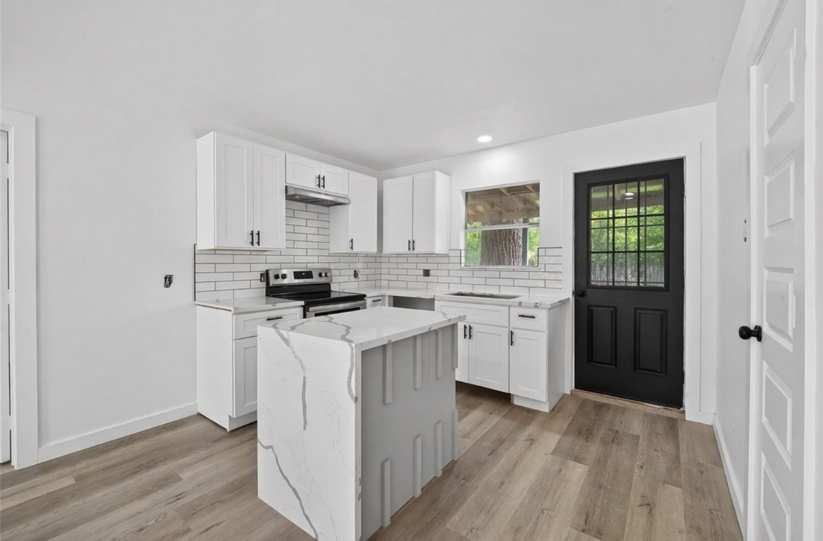 4933 Doolittle Boulevard Houston, TX 77033 - Photo 1 of 28 a kitchen with a stove a sink and a refrigerator