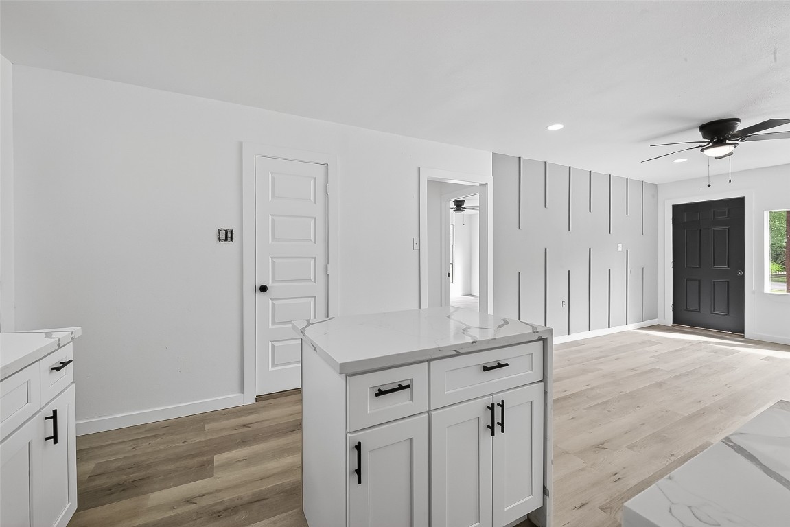 4933 Doolittle Boulevard Houston, TX 77033 - Photo 11 of 28 a kitchen with white cabinets and wooden floors