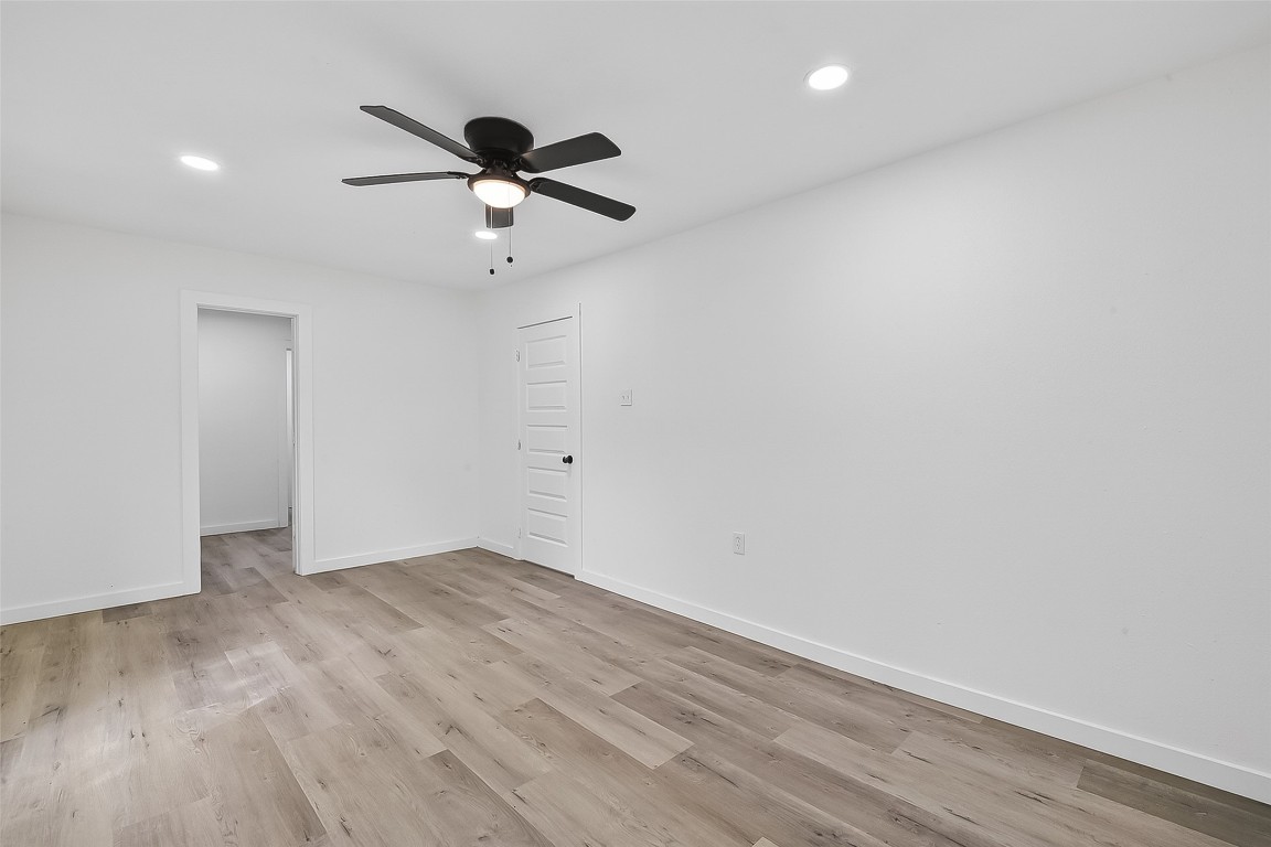 4933 Doolittle Boulevard Houston, TX 77033 - Photo 13 of 28 wooden floor in an empty room