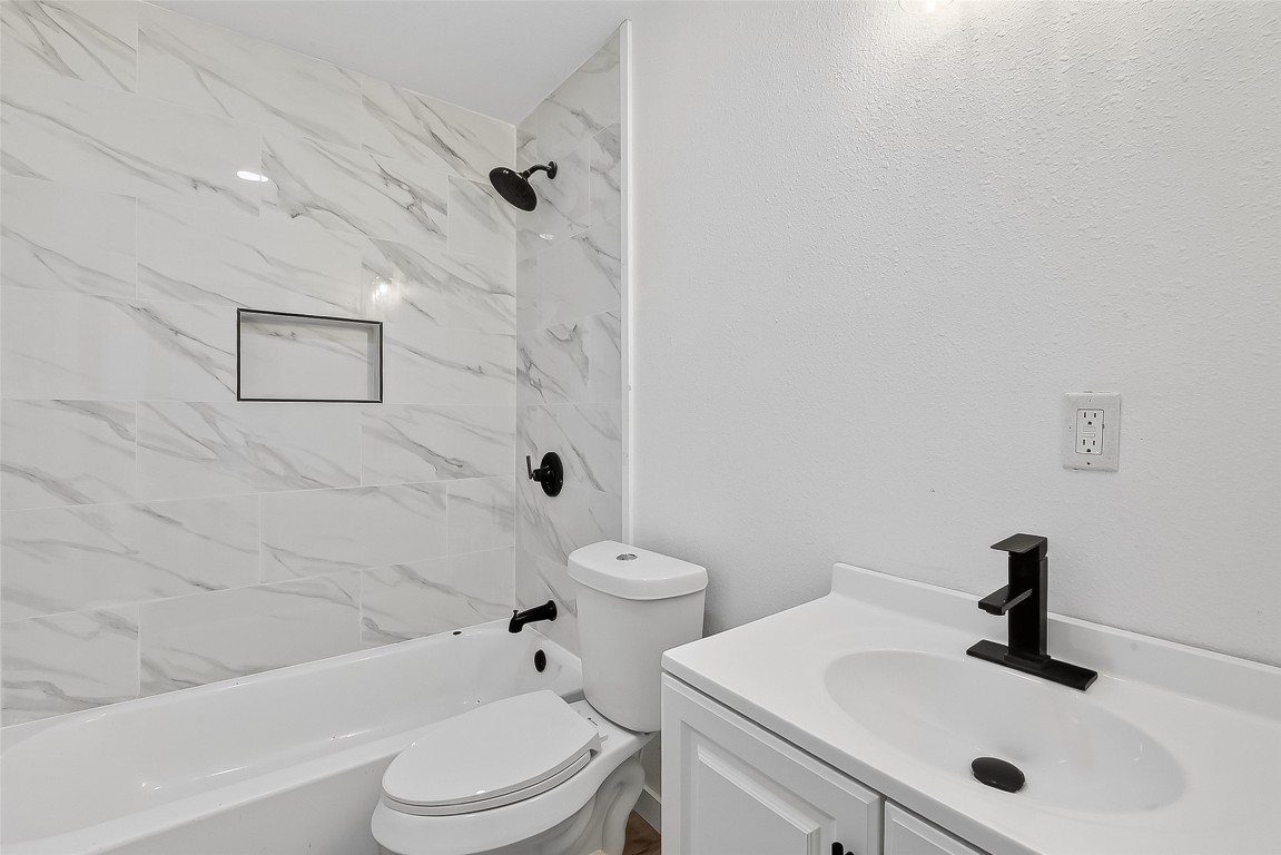 4933 Doolittle Boulevard Houston, TX 77033 - Photo 19 of 28 a bathroom with a sink toilet and shower