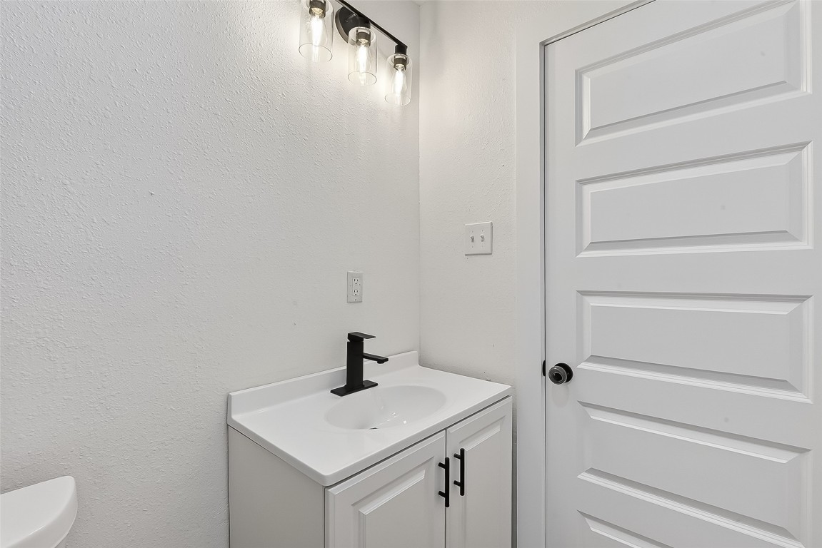 4933 Doolittle Boulevard Houston, TX 77033 - Photo 20 of 28 a bathroom with a sink and mirror