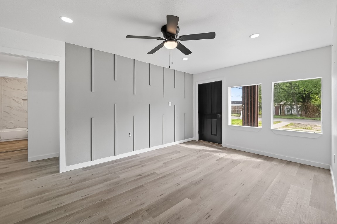 4933 Doolittle Boulevard Houston, TX 77033 - Photo 4 of 28 a view of an empty room with wooden floor and a window