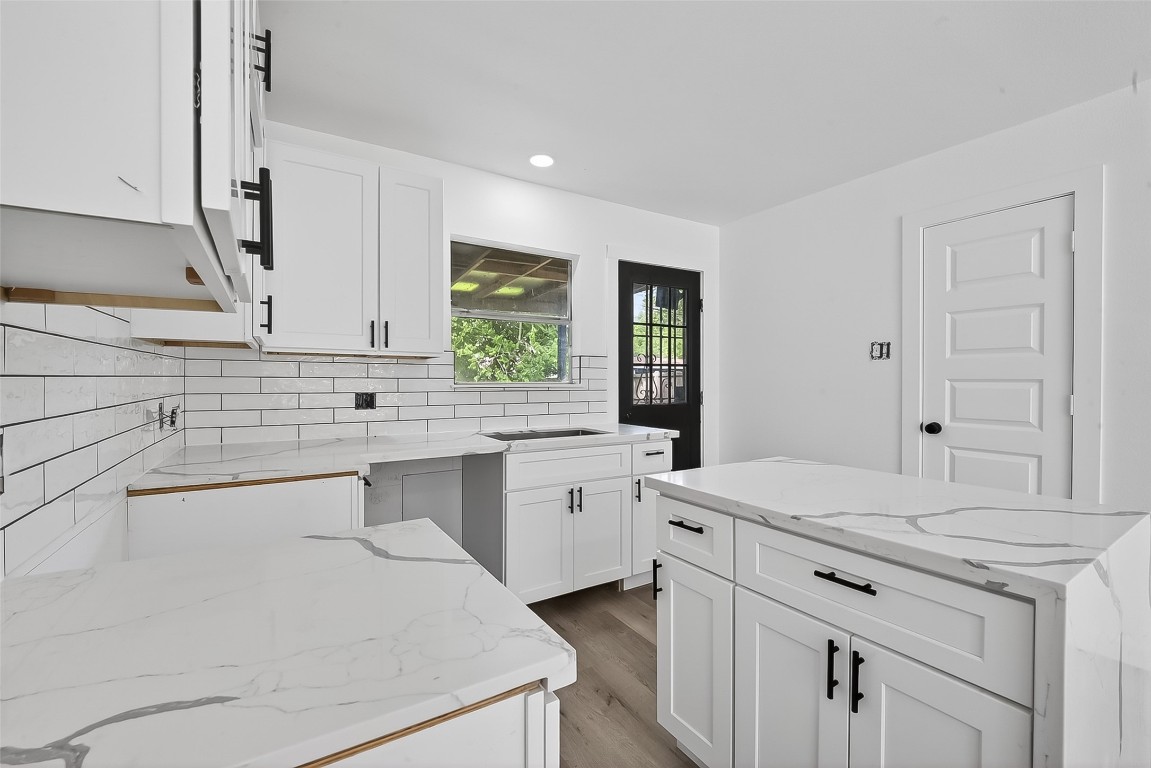 4933 Doolittle Boulevard Houston, TX 77033 - Photo 9 of 28 a kitchen with a sink stove and cabinets