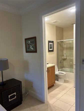 a bathroom with a granite countertop sink a toilet and shower