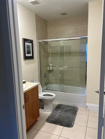 a bathroom with a shower a toilet and a sink
