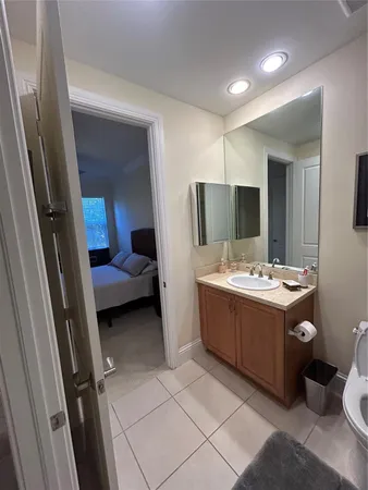 a spacious bedroom with a bed and a chandelier