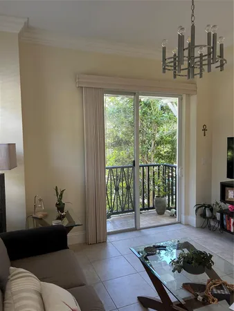 a living room with furniture and a floor to ceiling window
