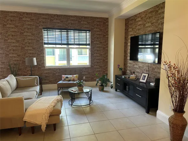 a living room with furniture a chandelier and a dining table