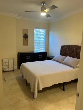 a bedroom with a bed and a night stand