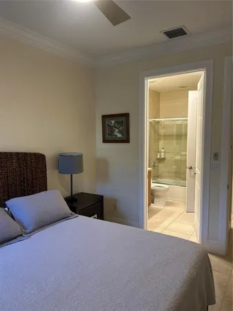 a bedroom with a bed and a lamp