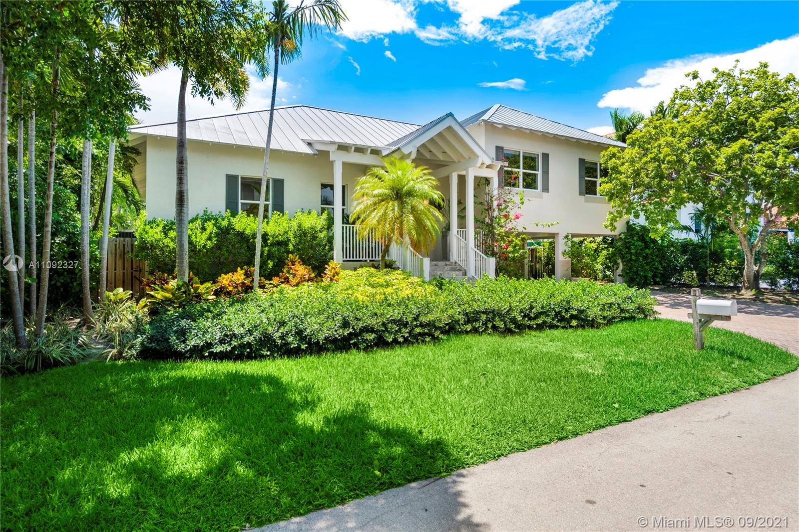 280 Ridgewood Road Key Biscayne, FL 33149 - Photo 1 of 30 a front view of a house with a garden
