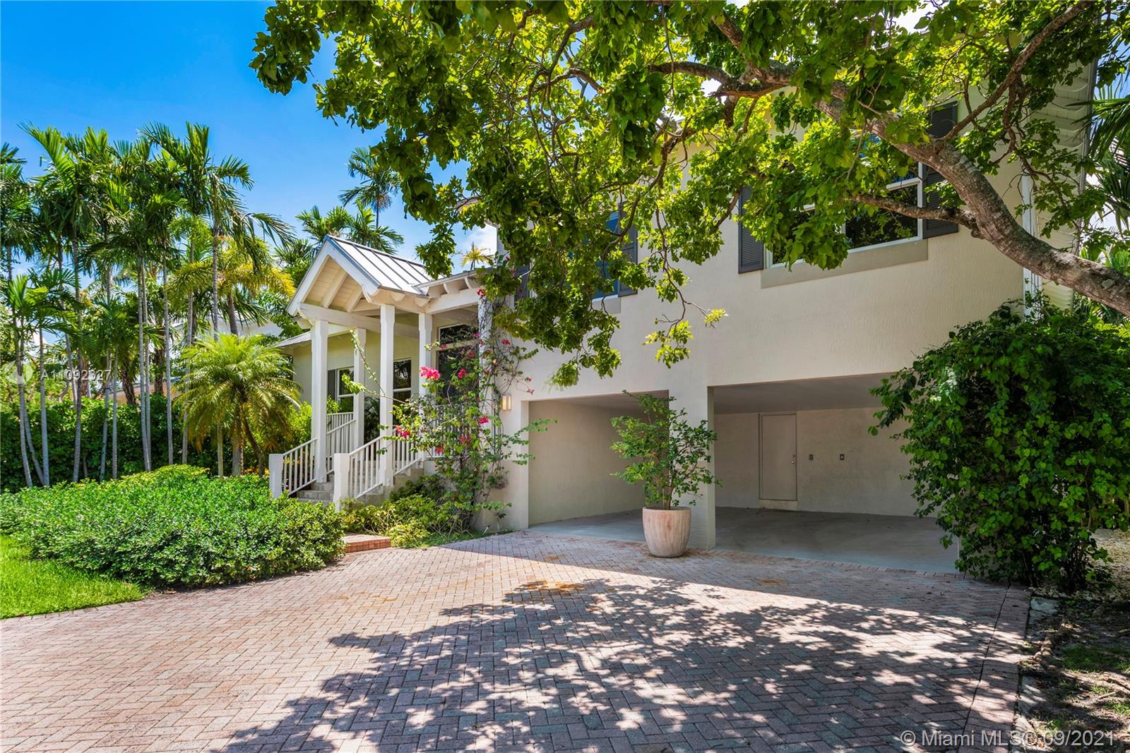 280 Ridgewood Road Key Biscayne, FL 33149 - Photo 2 of 30 front view of a house with a yard