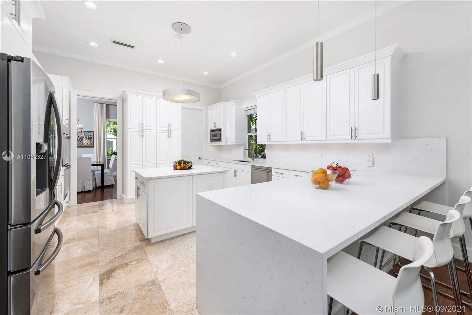 280 Ridgewood Road Key Biscayne, FL 33149 - Photo 13 of 30 a kitchen that has a lot of white cabinets and stainless steel appliances