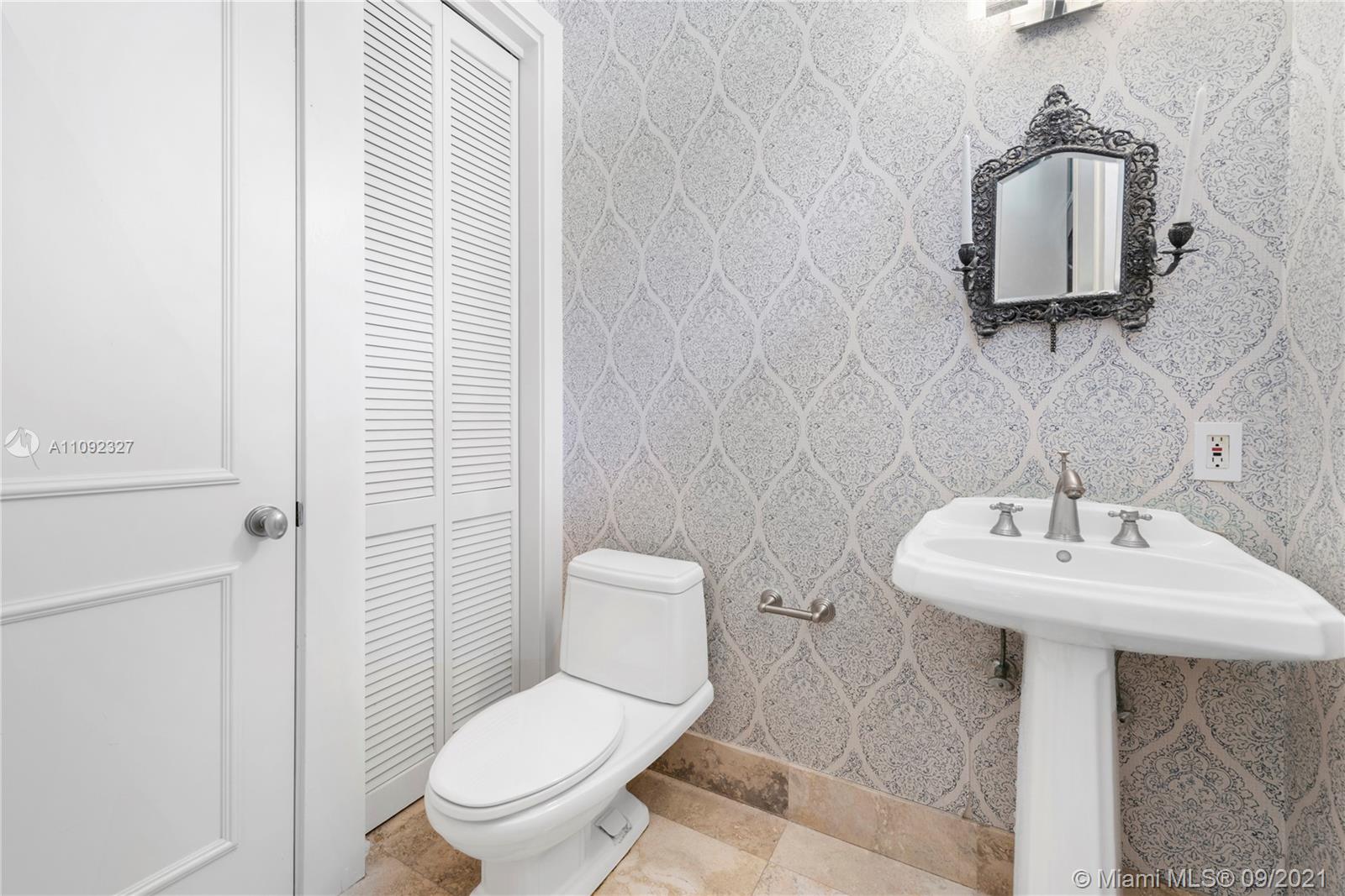 280 Ridgewood Road Key Biscayne, FL 33149 - Photo 16 of 30 a bathroom with a toilet sink and mirror