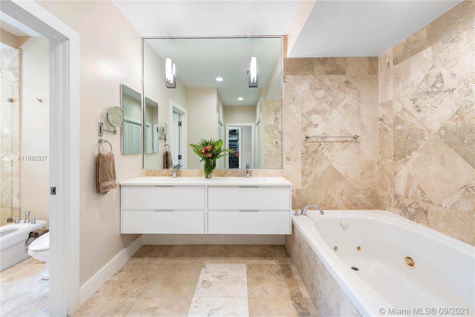 280 Ridgewood Road Key Biscayne, FL 33149 - Photo 19 of 30 a bathroom with a bathtub a sink and a shower