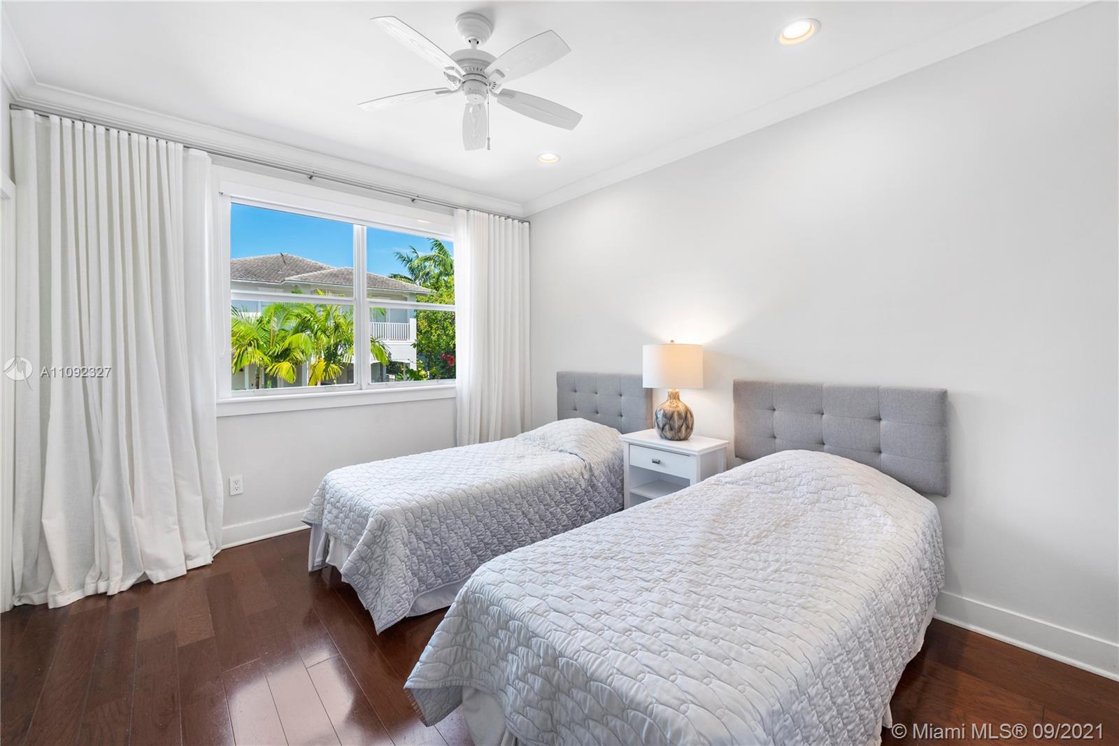 280 Ridgewood Road Key Biscayne, FL 33149 - Photo 21 of 30 a bedroom with two beds and a window