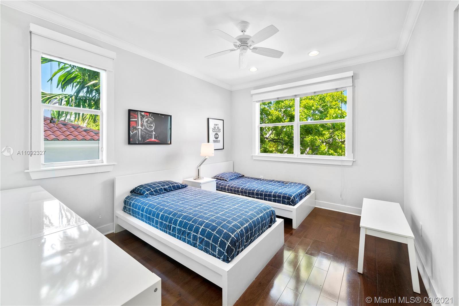 280 Ridgewood Road Key Biscayne, FL 33149 - Photo 23 of 30 a bed sitting in a bedroom next to a window