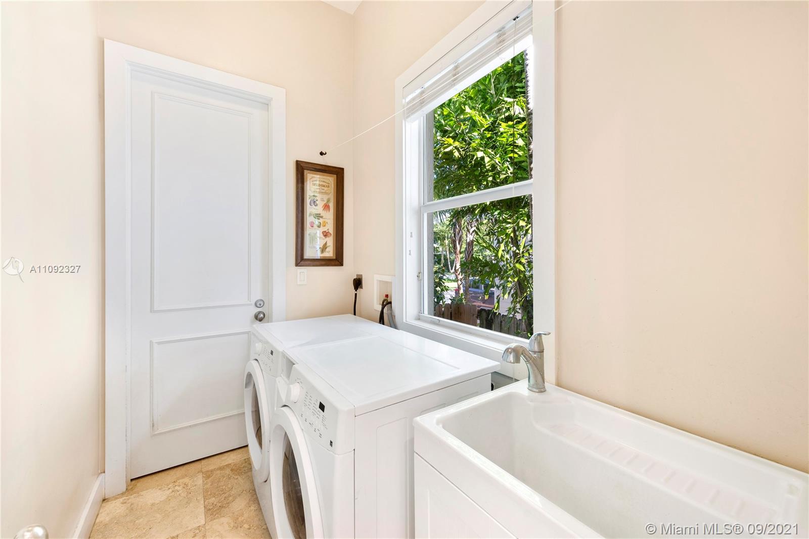 280 Ridgewood Road Key Biscayne, FL 33149 - Photo 27 of 30 a bathroom with a tub sink and window