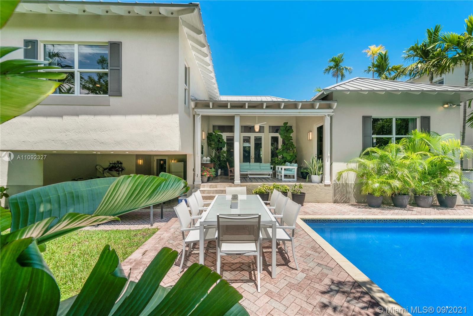 280 Ridgewood Road Key Biscayne, FL 33149 - Photo 30 of 30 a view of a patio with couches table and chairs with plants and garden