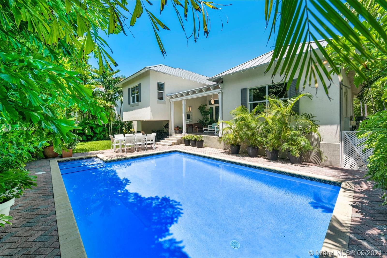 280 Ridgewood Road Key Biscayne, FL 33149 - Photo 4 of 30 a swimming pool with outdoor seating and yard
