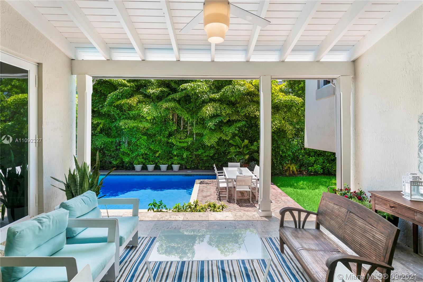 280 Ridgewood Road Key Biscayne, FL 33149 - Photo 6 of 30 a view of a patio with table and chairs potted plants with wooden floor