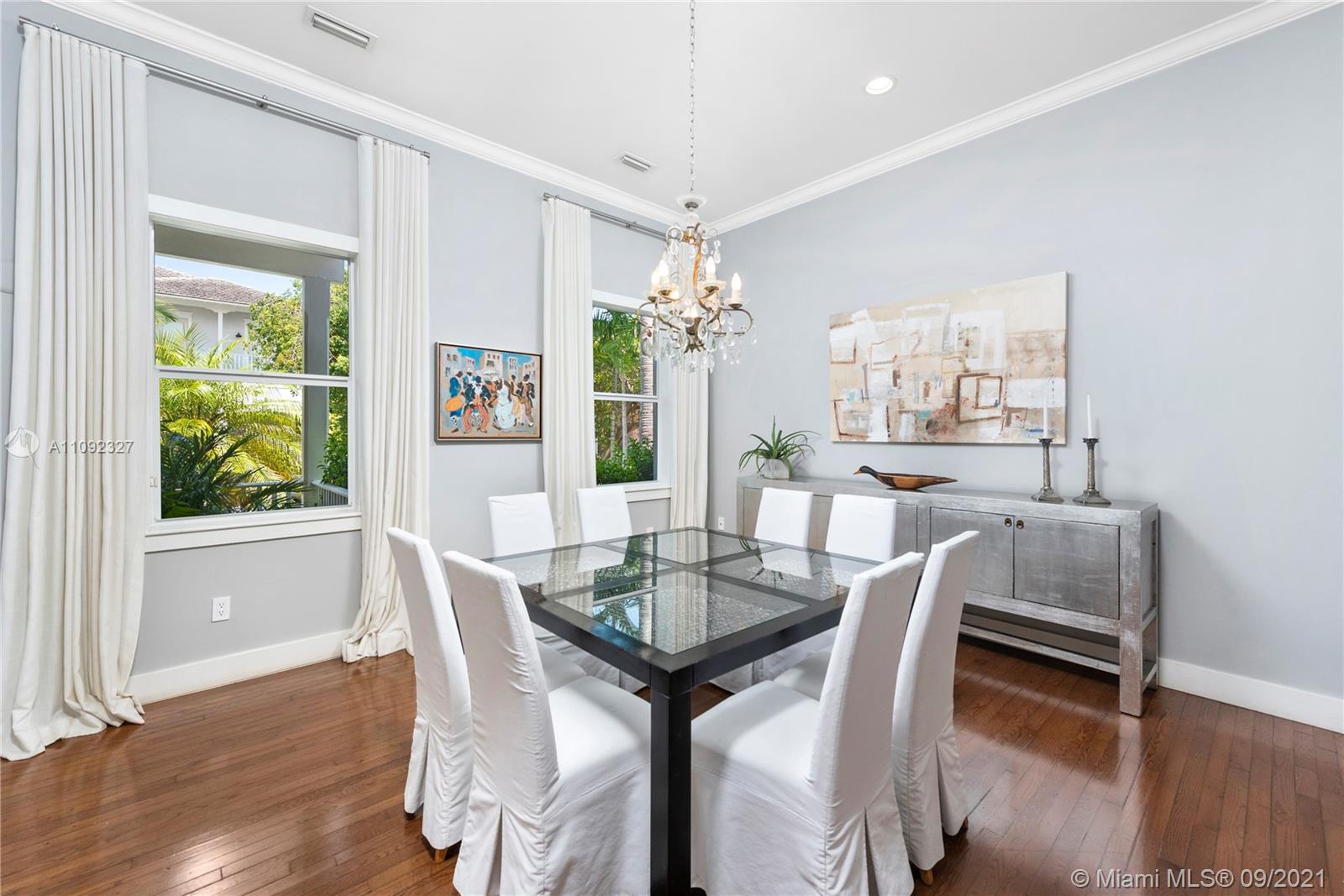 280 Ridgewood Road Key Biscayne, FL 33149 - Photo 10 of 30 a dining room with furniture potted plants and wooden floor