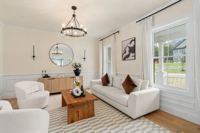 a living room with furniture a rug and a window