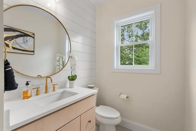 a bathroom with a toilet sink and mirror