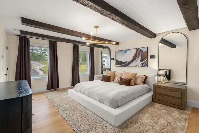 a bedroom with a large bed and a chandelier