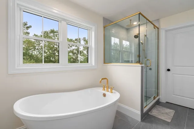 a white bath tub sitting next to a window