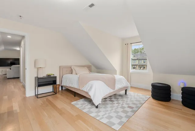 a spacious bedroom with a bed and a couch