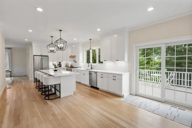 a large white kitchen with a large window