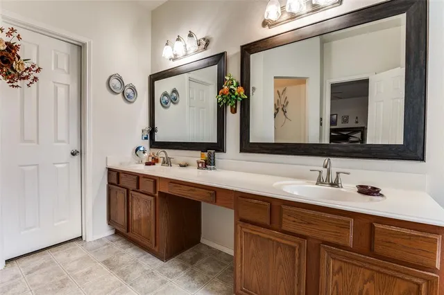a bathroom with a double vanity sink and a mirror