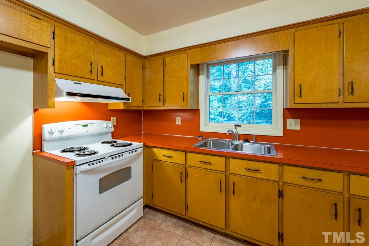 3715 Bahama Road Rougemont, NC 27572 - Photo 12 of 30 a kitchen with stainless steel appliances granite countertop white cabinets and a stove top oven