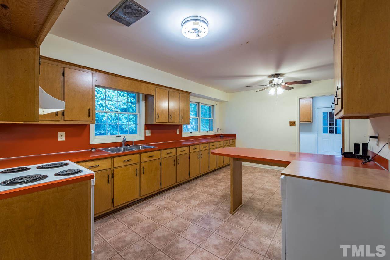3715 Bahama Road Rougemont, NC 27572 - Photo 13 of 30 a kitchen with stainless steel appliances granite countertop a sink and a stove